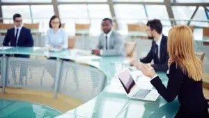 Business meeting reviewing emails on laptop