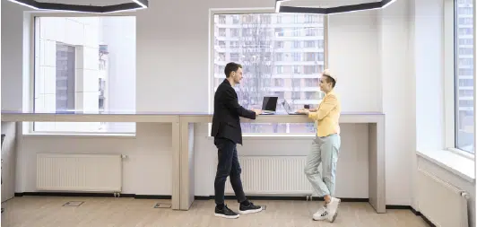 coworkers in office discussing a new way to fax through the cloud