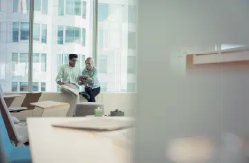 Coworkers chatting about becoming cloud-first with ETHERFAX